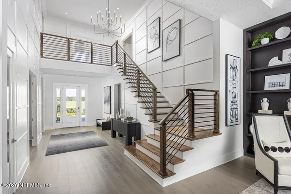 a view of entryway and hall with wooden floor