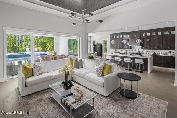 a living room with fireplace furniture and a large window
