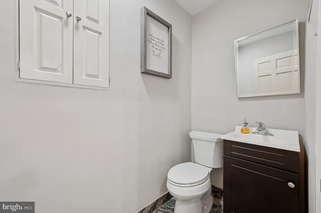 a bathroom with a sink toilet and vanity