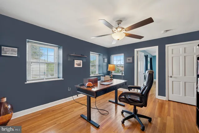 a view of a workspace with furniture and a window