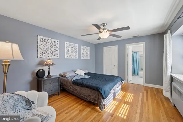 a bedroom with a bed chandelier and a window