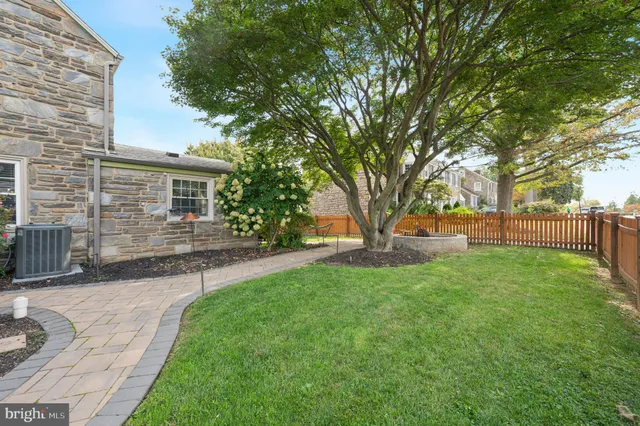 a view of backyard of house with green space