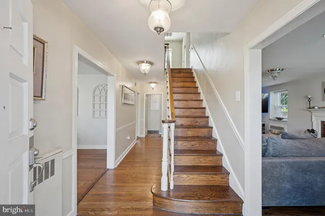 a view of entryway and hall with wooden floor