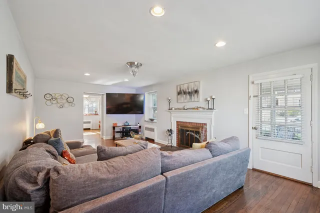 a living room with furniture fireplace and flat screen tv