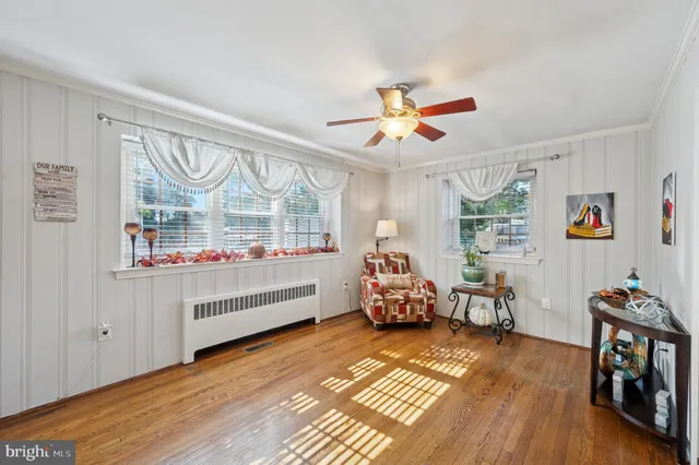 a bedroom with furniture and a wooden floor