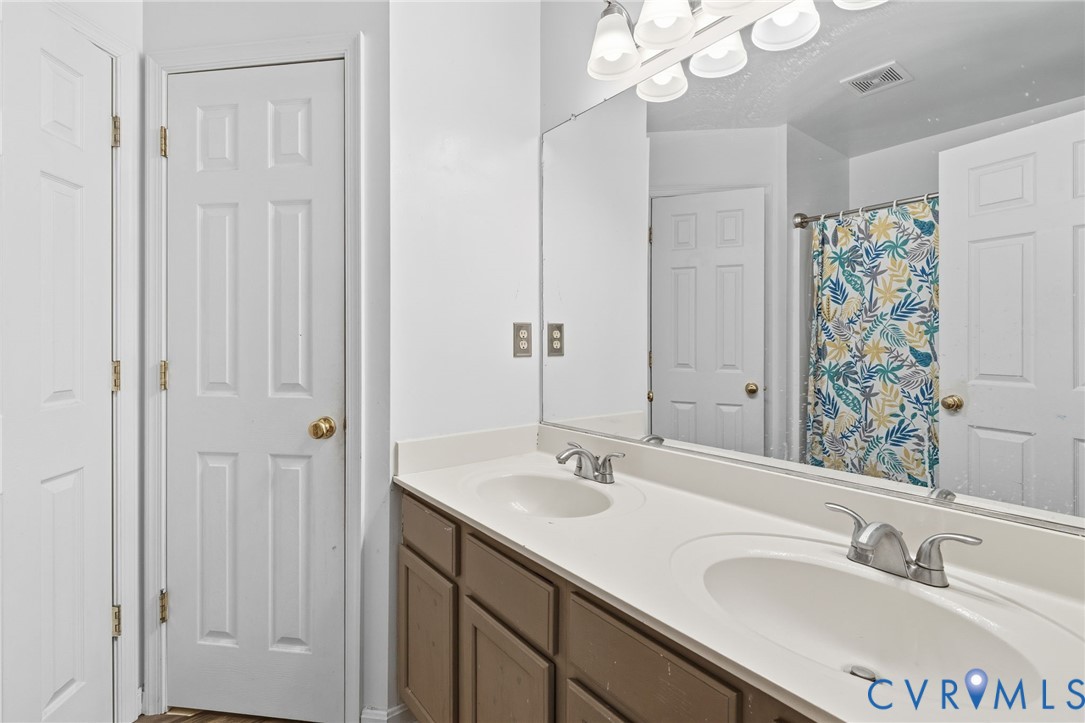 204 Village Court Ruther Glen, VA 22546 - Photo 11 of 27 a bathroom with a sink double vanity and a mirror