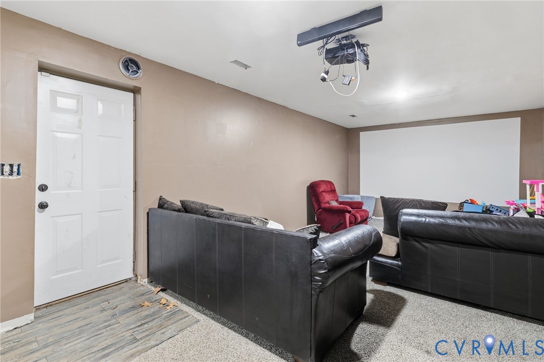 204 Village Court Ruther Glen, VA 22546 - Photo 16 of 27 a living room with furniture and a chandelier