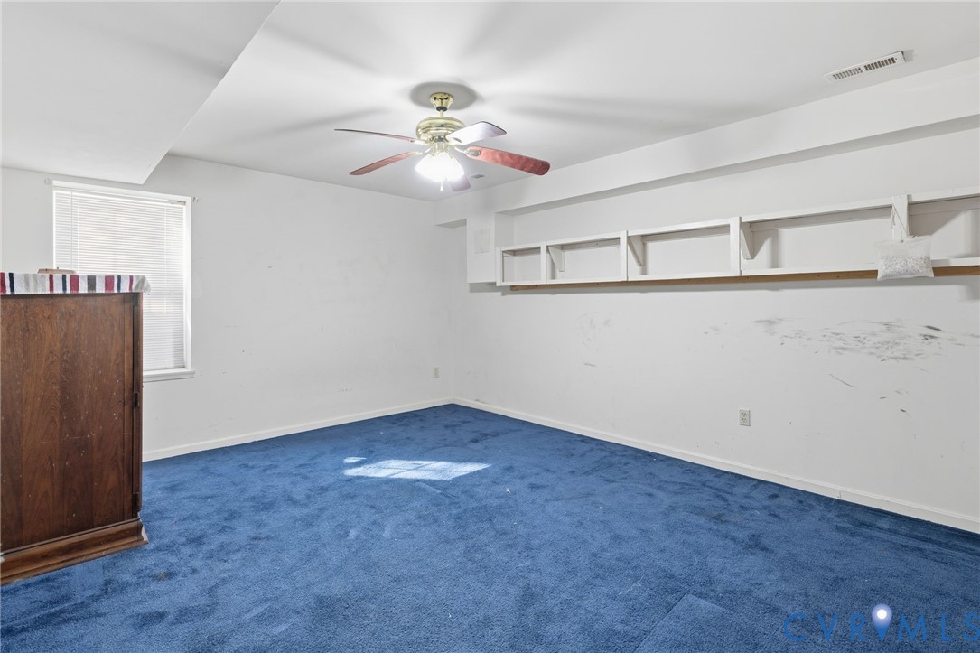 204 Village Court Ruther Glen, VA 22546 - Photo 17 of 27 an empty room with windows and fan