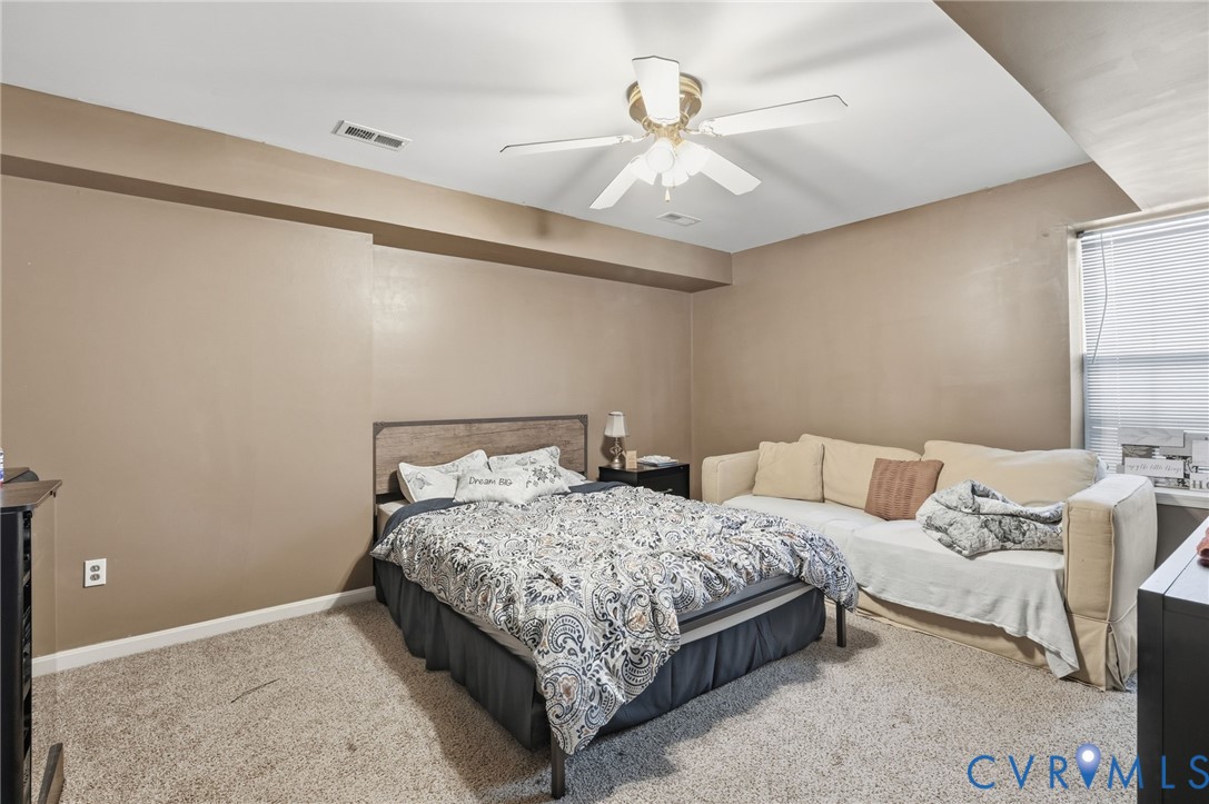 204 Village Court Ruther Glen, VA 22546 - Photo 18 of 27 a bedroom with a bed and a ceiling fan
