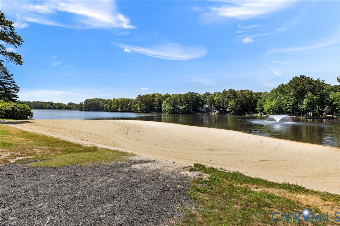 204 Village Court Ruther Glen, VA 22546 - Photo 22 of 27 a view of a lake with houses in the back