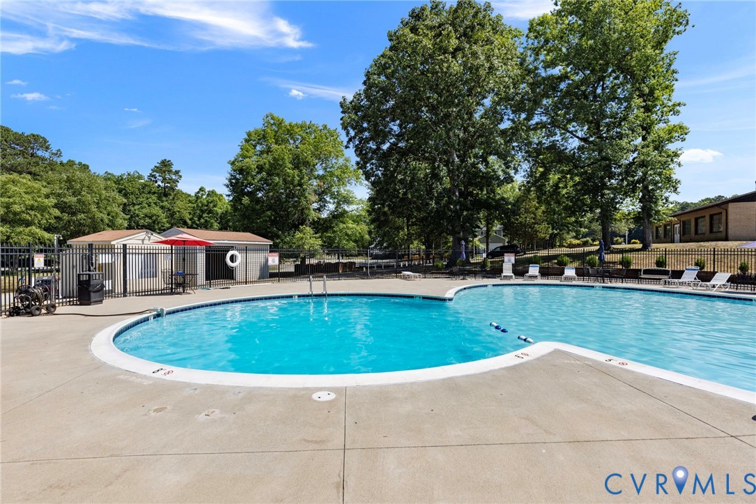 204 Village Court Ruther Glen, VA 22546 - Photo 24 of 27 a view of a swimming pool with lawn chairs
