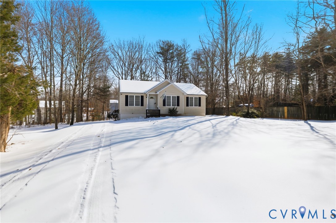 204 Village Court Ruther Glen, VA 22546 - Photo 3 of 27 a view of a white house with a yard covered in snow