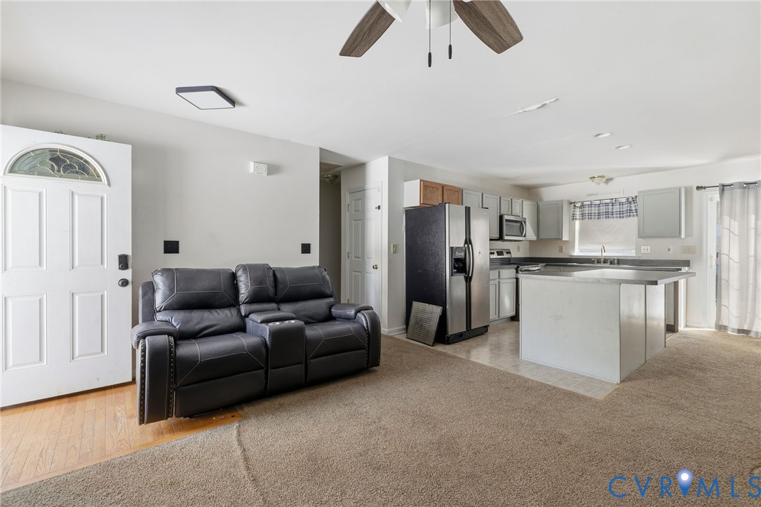 204 Village Court Ruther Glen, VA 22546 - Photo 5 of 27 a living room with furniture and kitchen view