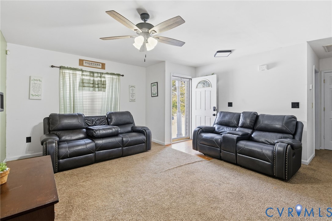 204 Village Court Ruther Glen, VA 22546 - Photo 6 of 27 a living room with furniture and a large window