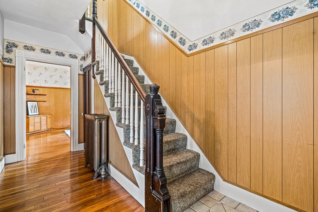 14 Hancock Street Stoneham, MA 02180 - Photo 15 of 38 a view of a hallway with wooden floor and staircase