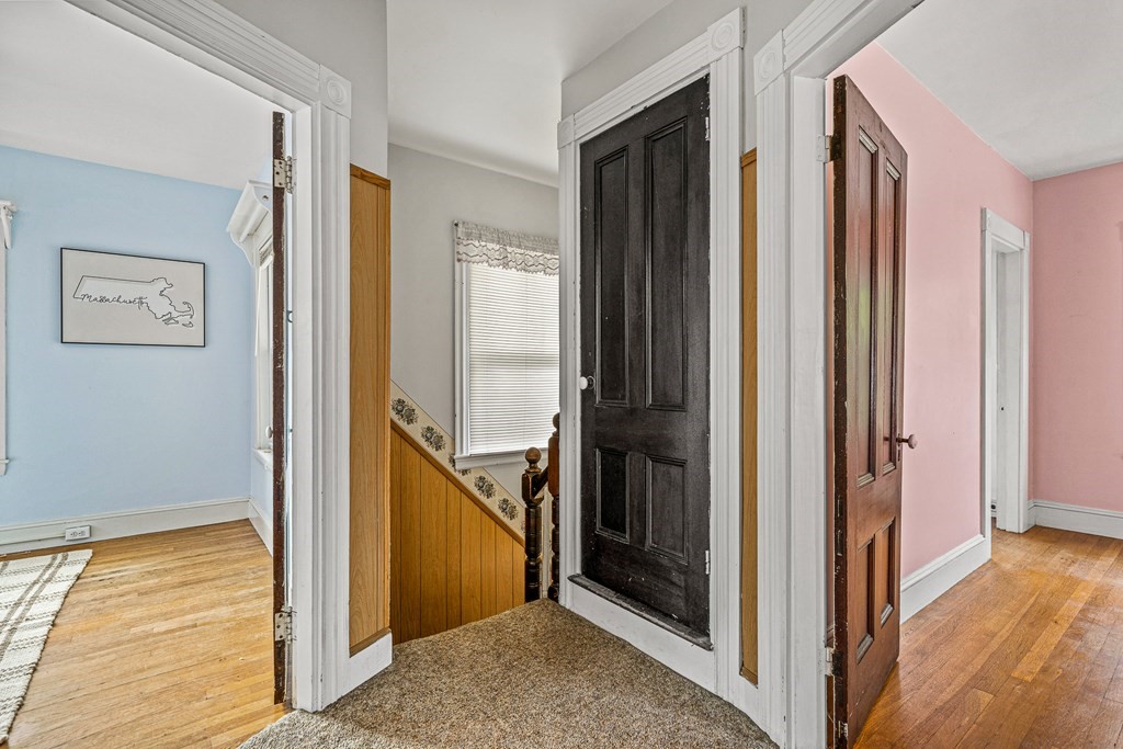 14 Hancock Street Stoneham, MA 02180 - Photo 25 of 38 a view of a hallway with wooden floor and staircase