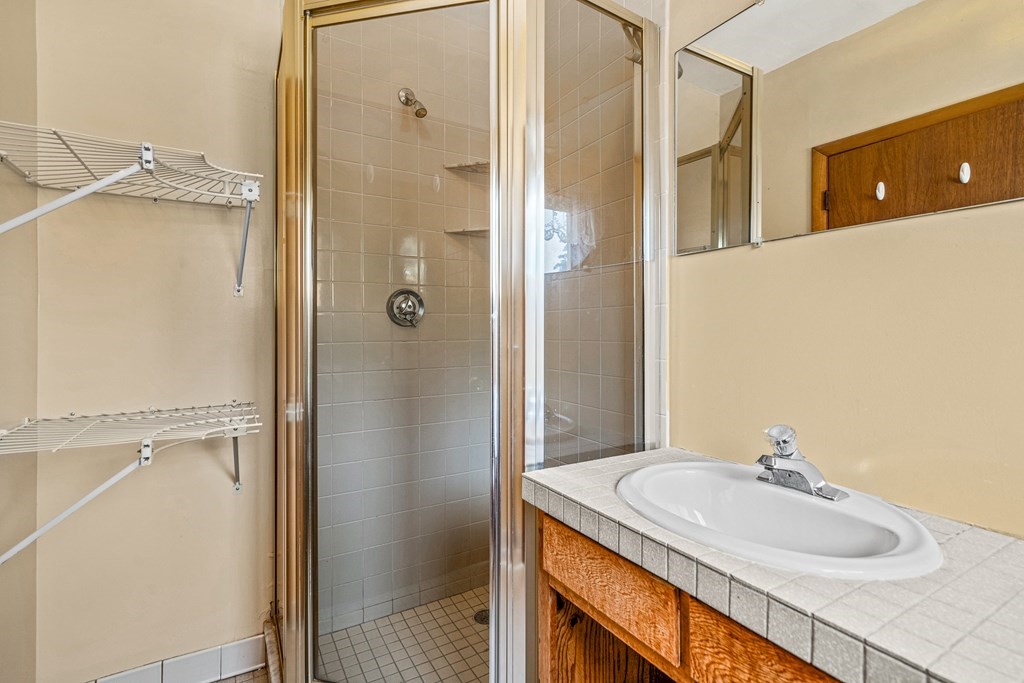 14 Hancock Street Stoneham, MA 02180 - Photo 30 of 38 a bathroom with a granite countertop sink shower and a mirror