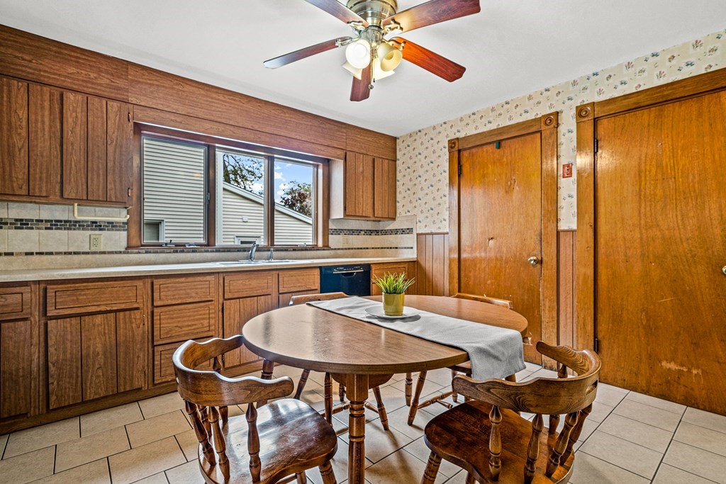 14 Hancock Street Stoneham, MA 02180 - Photo 10 of 38 a kitchen with a table chairs sink and cabinets