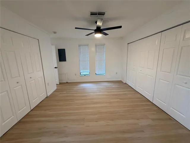 a front view of a house with a yard and trees