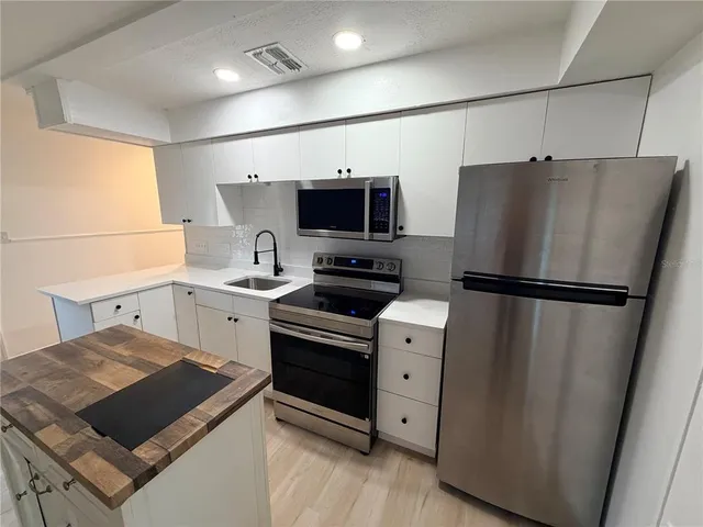 a kitchen with a refrigerator stove and sink