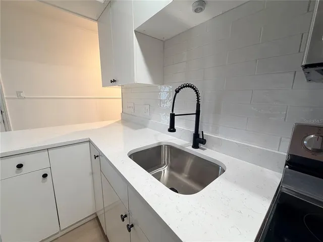 a room with wooden floor and white walls