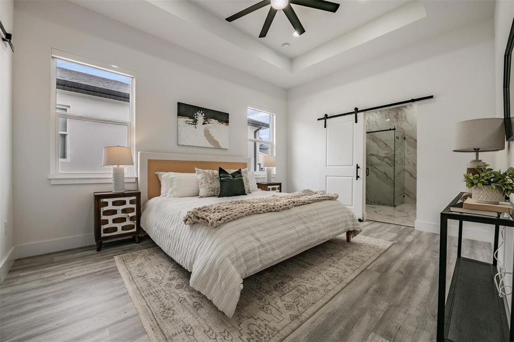 2305 West Kentucky Avenue Tampa, FL 33607 - Photo 11 of 26 a bedroom with a bed and a chandelier