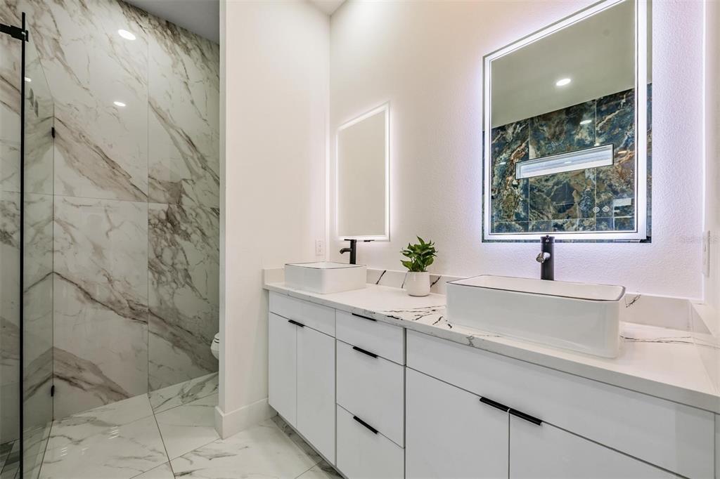 2305 West Kentucky Avenue Tampa, FL 33607 - Photo 13 of 26 a bathroom with a sink and a mirror