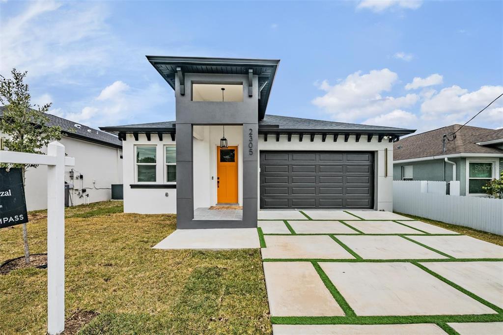 2305 West Kentucky Avenue Tampa, FL 33607 - Photo 2 of 26 a front view of a house with a yard