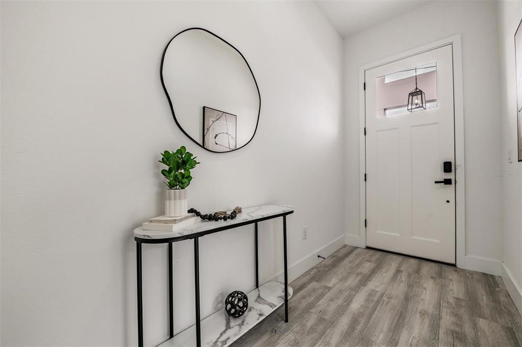 2305 West Kentucky Avenue Tampa, FL 33607 - Photo 4 of 26 a view of a hallway with wooden floor