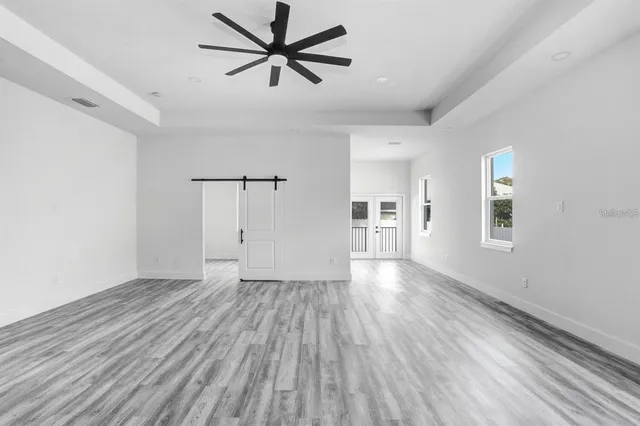 wooden floor in an empty room with a window