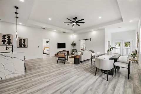 a living room with furniture and a wooden floor