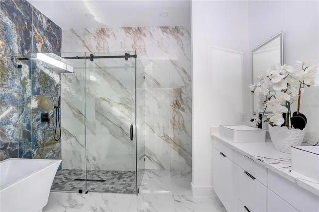 a bathroom with a sink and mirror with bathtub