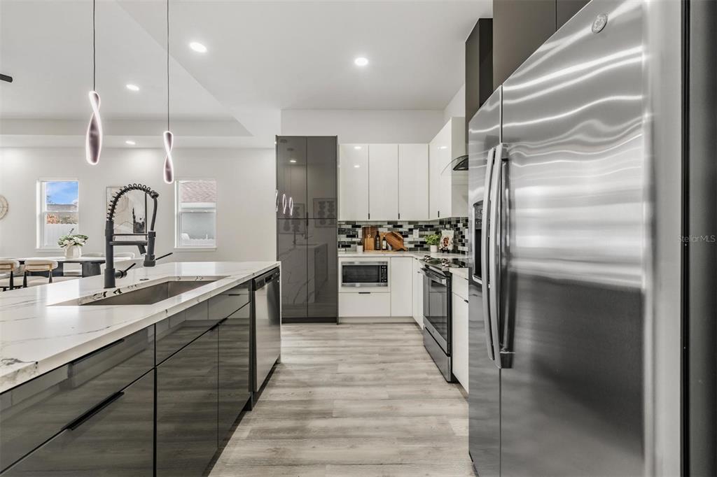 2305 West Kentucky Avenue Tampa, FL 33607 - Photo 10 of 26 a kitchen with kitchen island a counter top space a sink appliances and cabinets