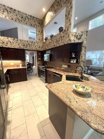 a kitchen with stainless steel appliances kitchen island granite countertop a sink and cabinets