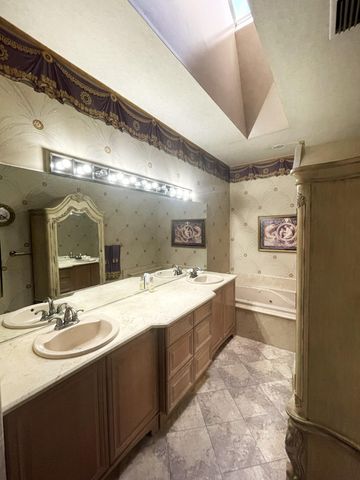 a large bathroom with a sink and a large mirror