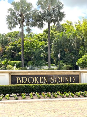 a view of a patio with lawn chairs under an umbrella