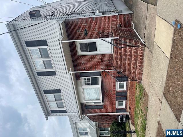 99 Union Avenue, Unit 2 Garfield, NJ 07026 - Photo 1 of 14 a front view of a house with a yard