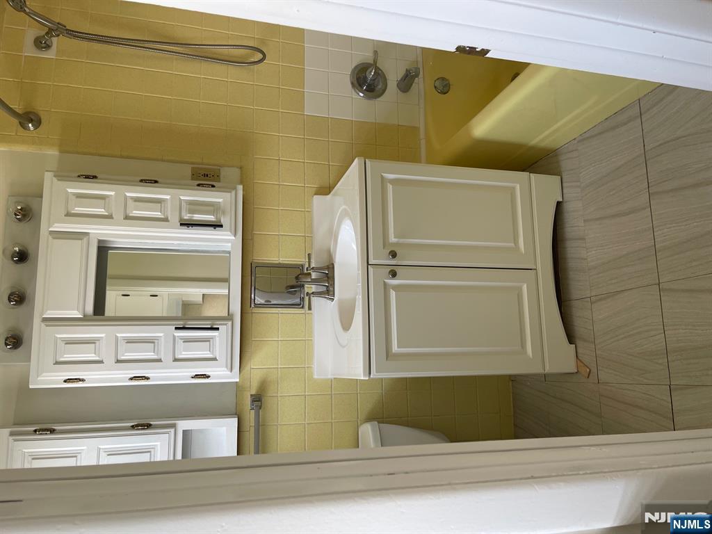99 Union Avenue, Unit 2 Garfield, NJ 07026 - Photo 13 of 14 a utility room with a sink a washer and dryer