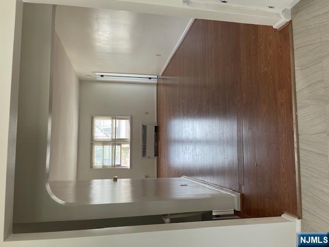 99 Union Avenue, Unit 2 Garfield, NJ 07026 - Photo 4 of 14 an empty room with wooden floor and windows