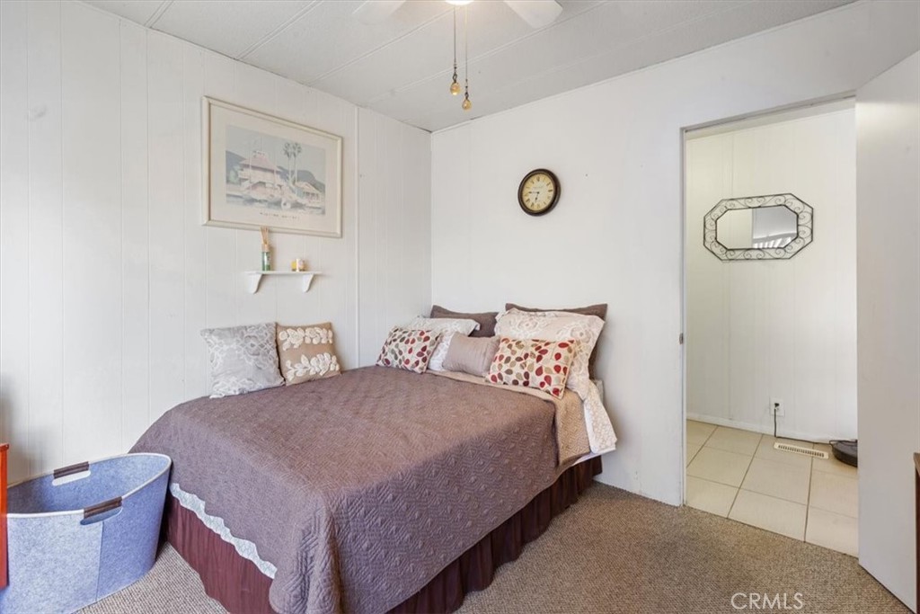 300 North Rampart Street, Unit 195 Orange, CA 92868 - Photo 16 of 25 a bedroom with a bed and a lamp on table