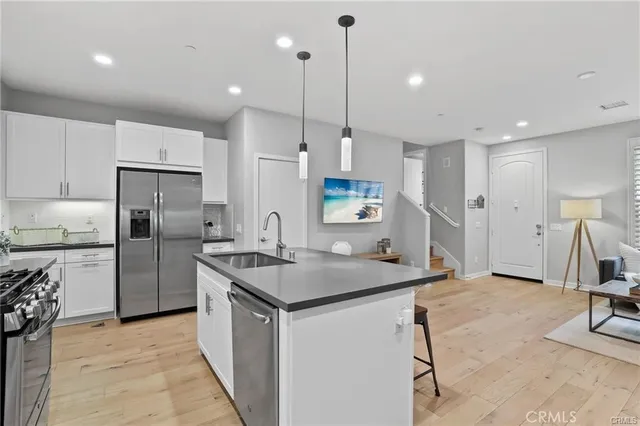 a kitchen with refrigerator and a sink