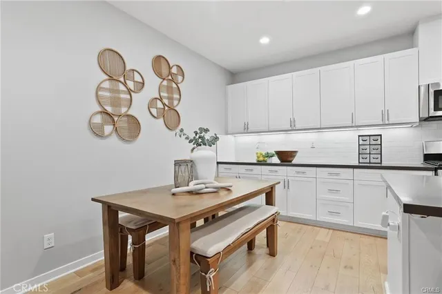 a kitchen with a sink cabinets and wooden floor