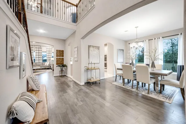 a living room with furniture a wooden floor and a large window
