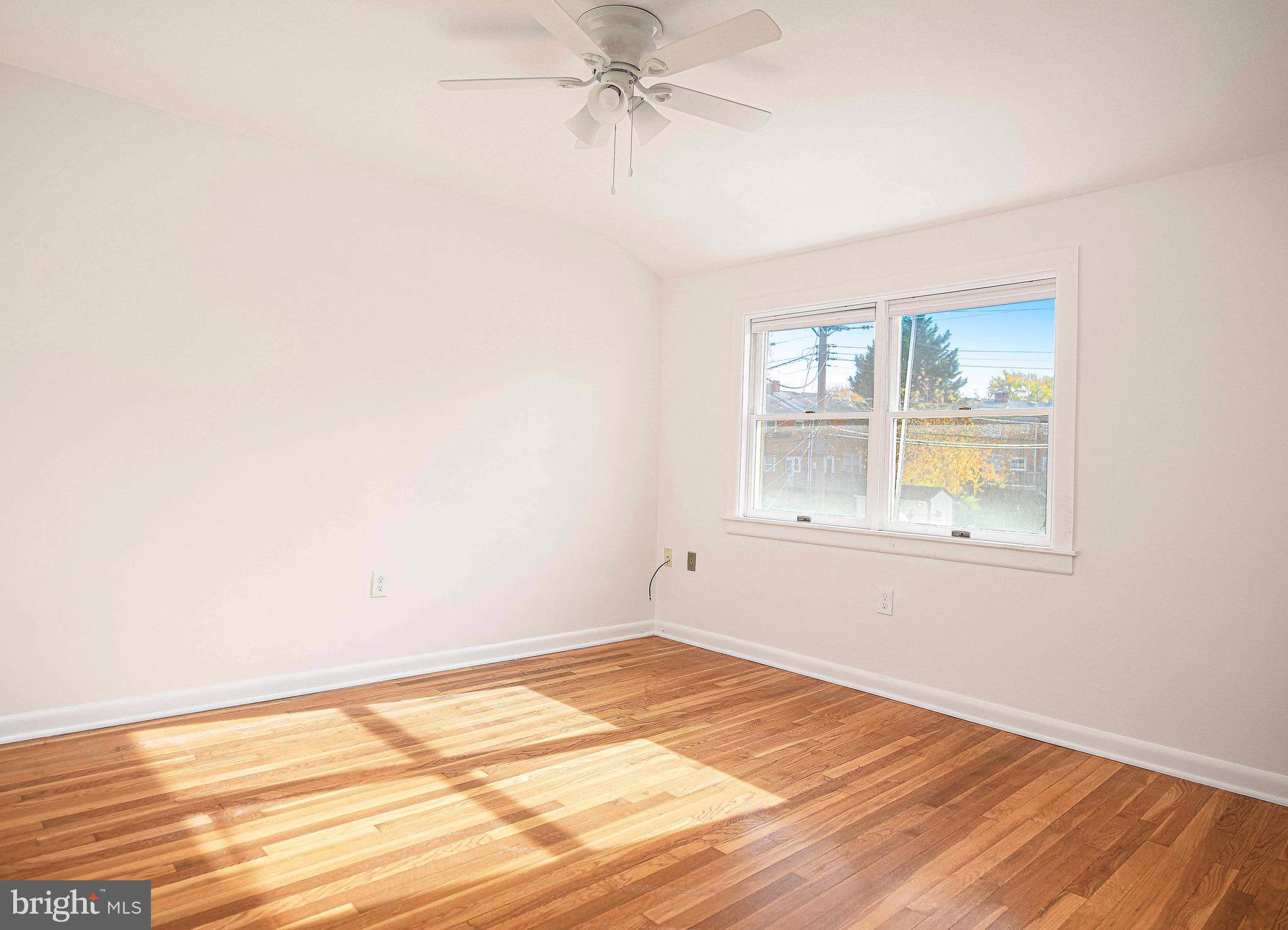 8559 Morven Road Baltimore, MD 21234 - Photo 15 of 27 an empty room with a window and wooden floor