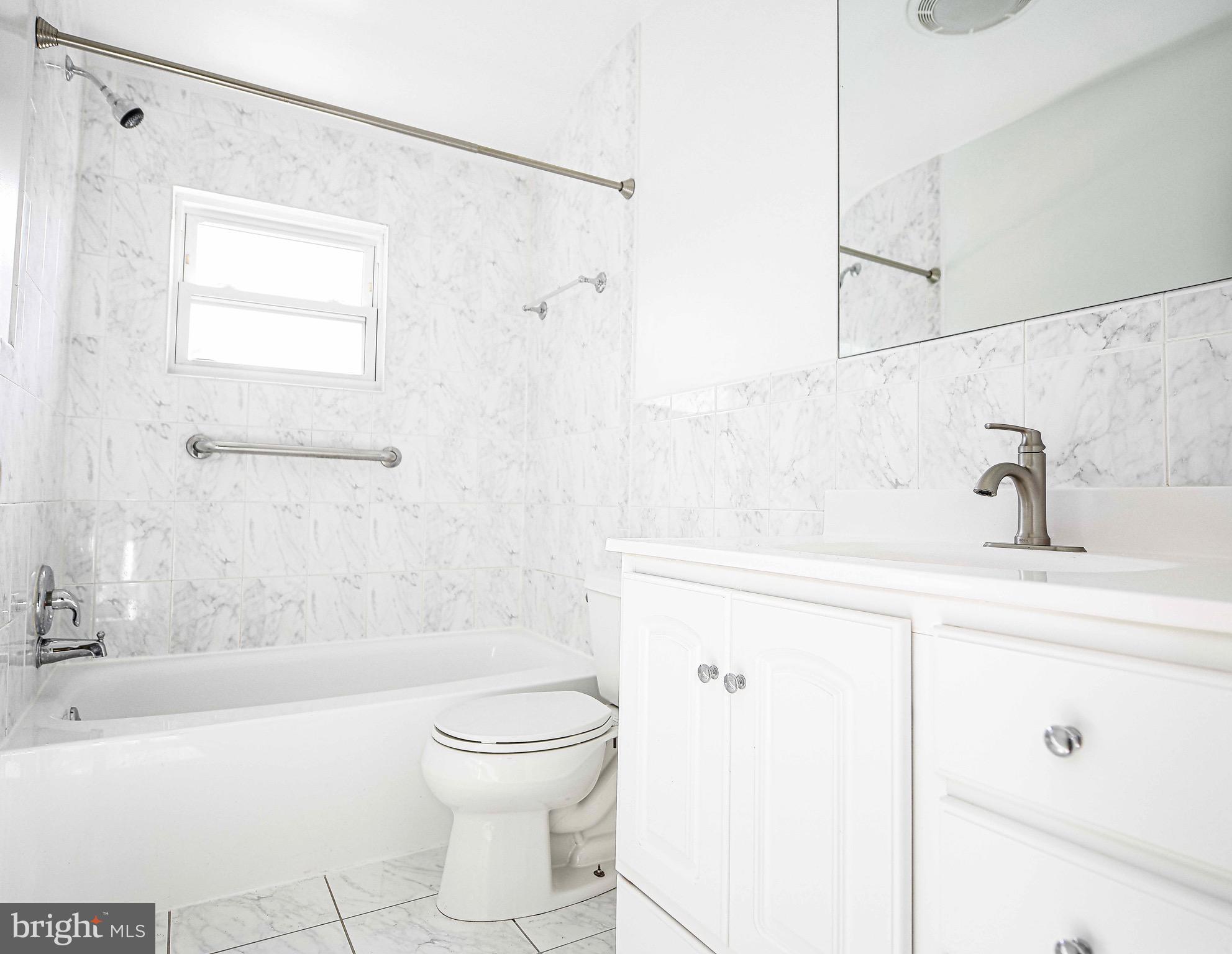 8559 Morven Road Baltimore, MD 21234 - Photo 17 of 27 a bathroom with a sink a toilet and shower