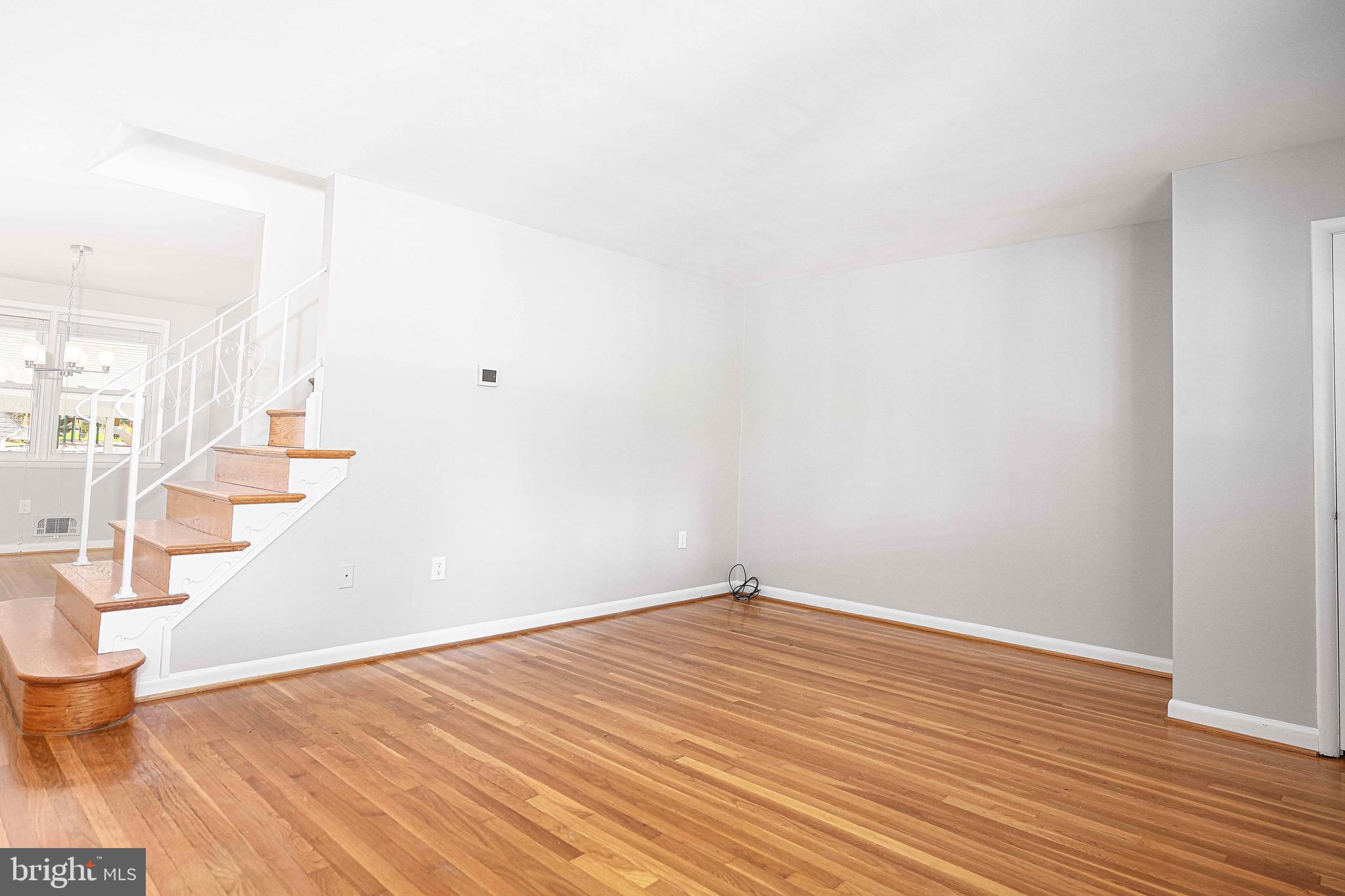 8559 Morven Road Baltimore, MD 21234 - Photo 6 of 27 a view of an empty room with wooden floor