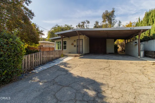 a view of a house with wooden fence