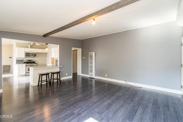 a view of kitchen with furniture and wooden floor