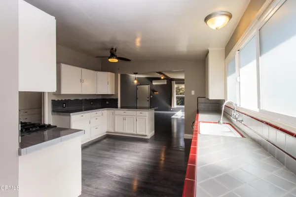 a kitchen with stainless steel appliances kitchen island granite countertop a stove a sink and a refrigerator