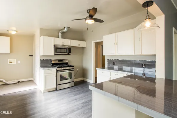 a kitchen with a stove a sink and a refrigerator
